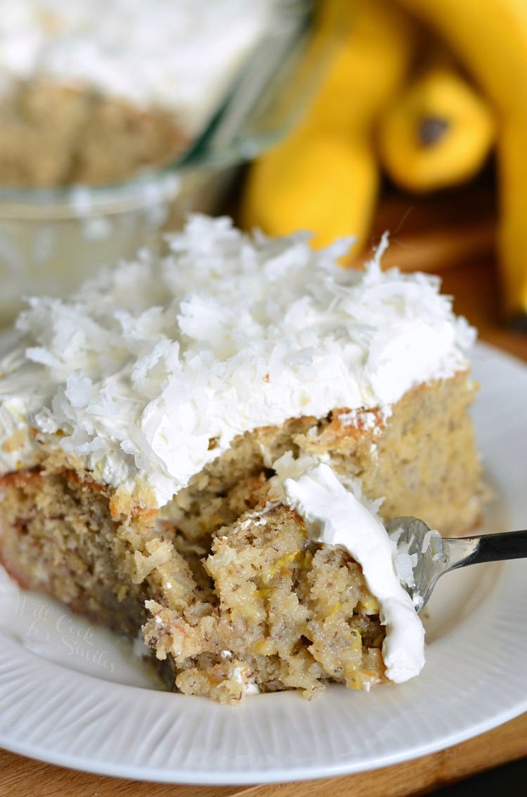 Lemon Coconut Banana Poke Cake in on a plate with a fork 