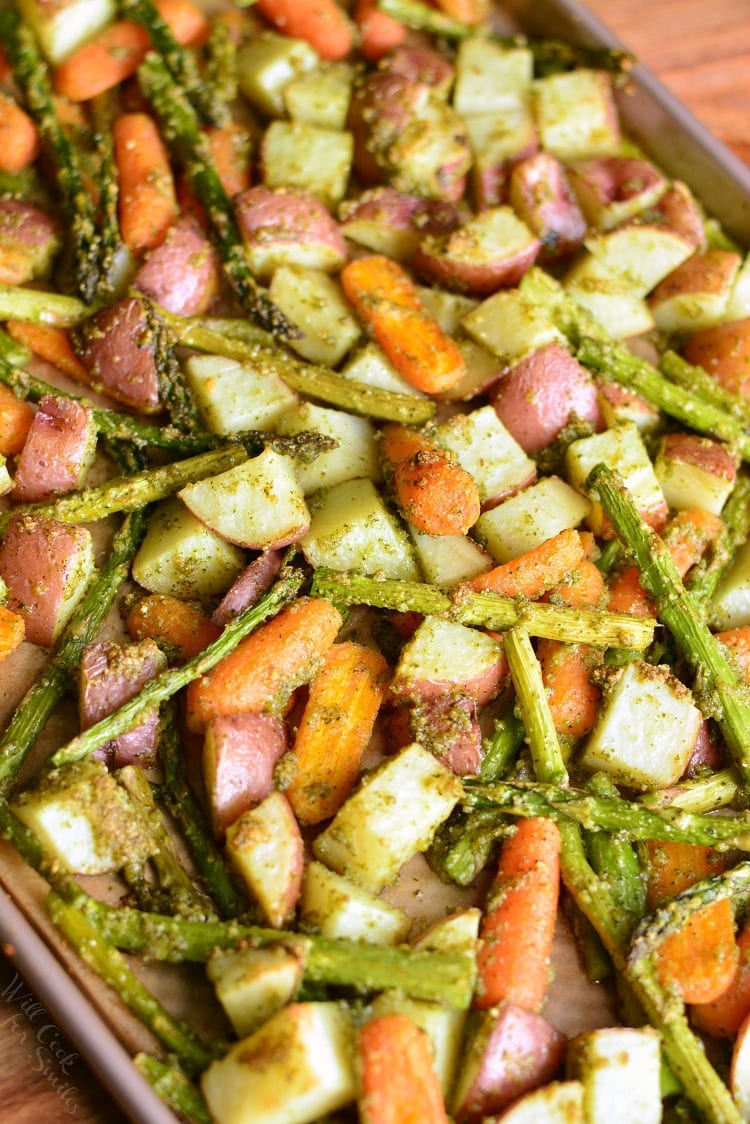Pesto Roasted Potatoes Carrots and Asparagus on a baking sheet 
