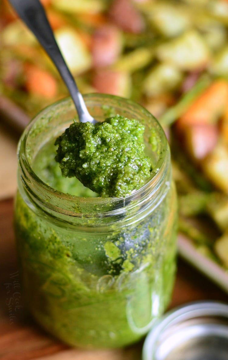 Homemade Pesto with Cashews in a jar with a spoon scooping some out 