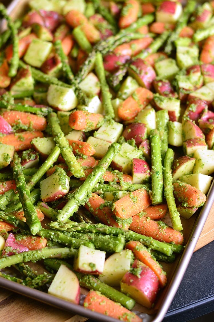 Pesto Roasted Potatoes Carrots and Asparagus on a baking sheet 