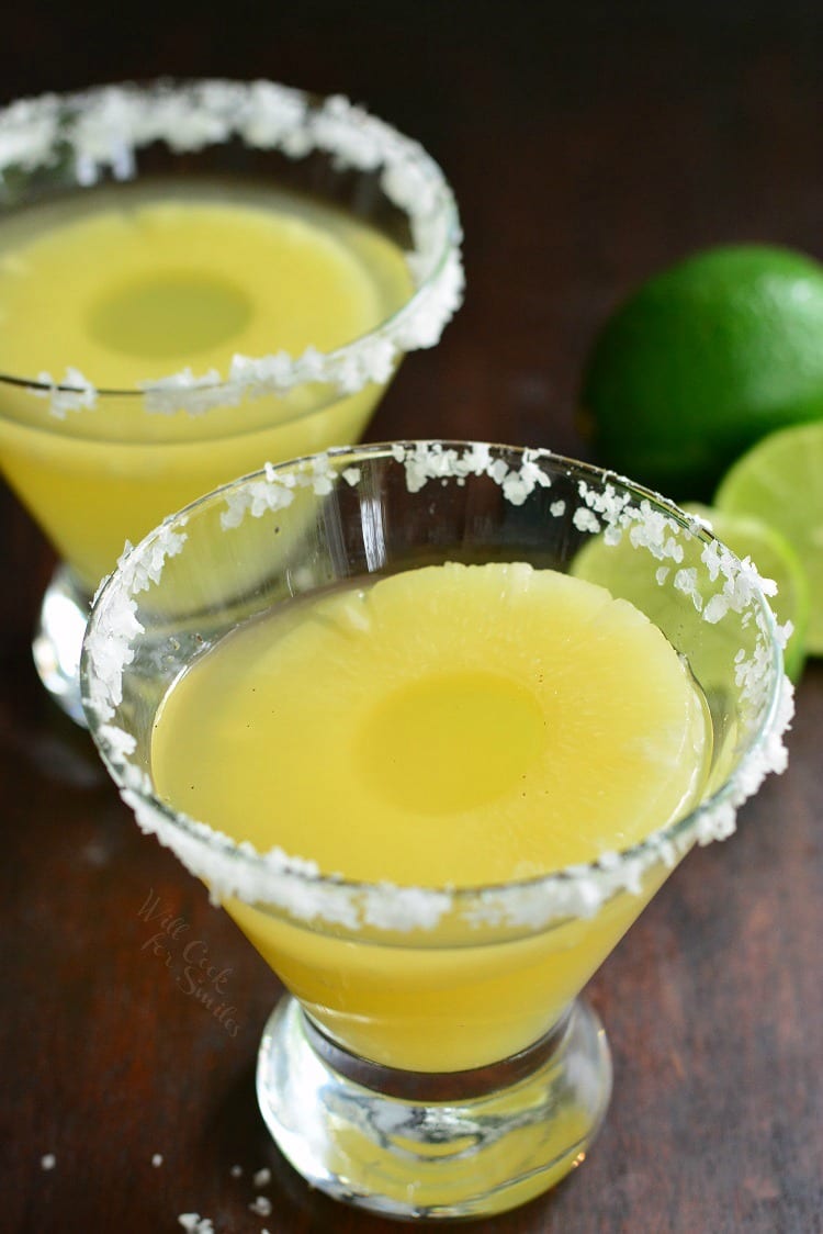 Pineapple Lime Margarita in a glass with pineapple ring and salted rim