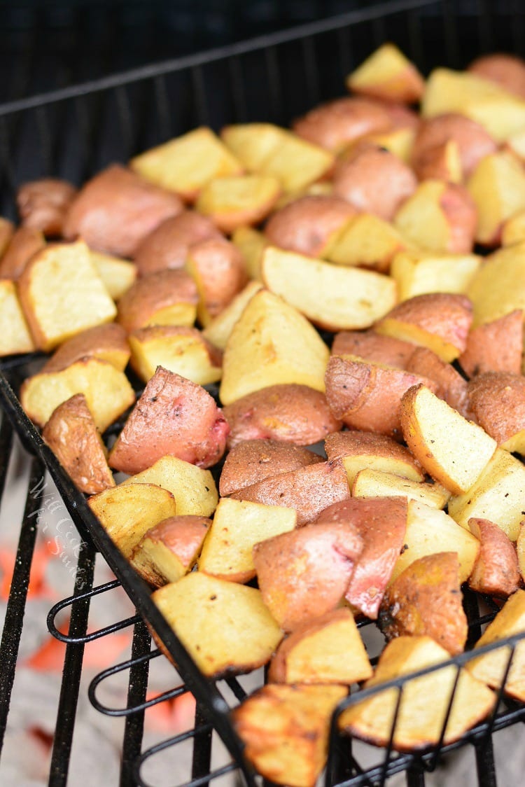 Roasted Garlic Potatoes in a grilling basket on the grill 