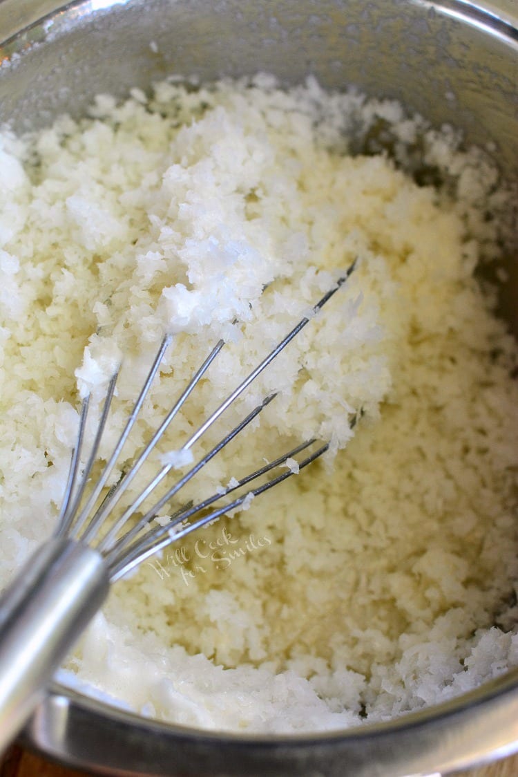 ingredients for Salted Cashew Coconut Macaroons in a metal bowl with a whisk 