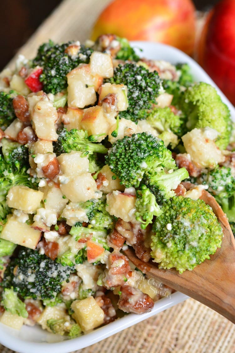 Pear Apple Broccoli Salad in a bowl with a wooden spoon 