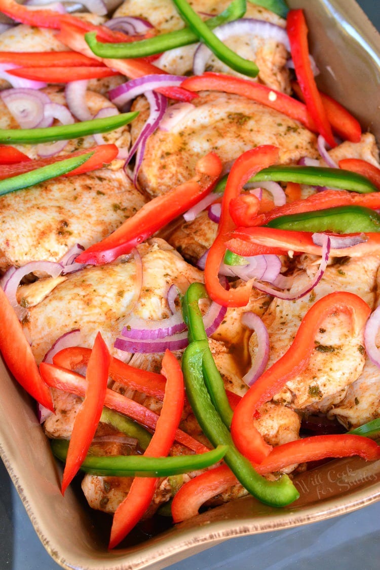 Southwest Chicken Marinade and Baked Chicken with green and red bell peppers and red onion in a casserole dish 