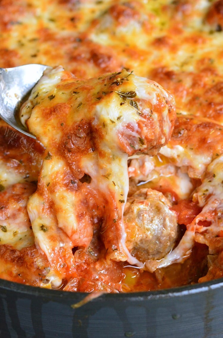 Cheesy Meatball Dip recipe in a pan with a meatball being lifted with by a fork