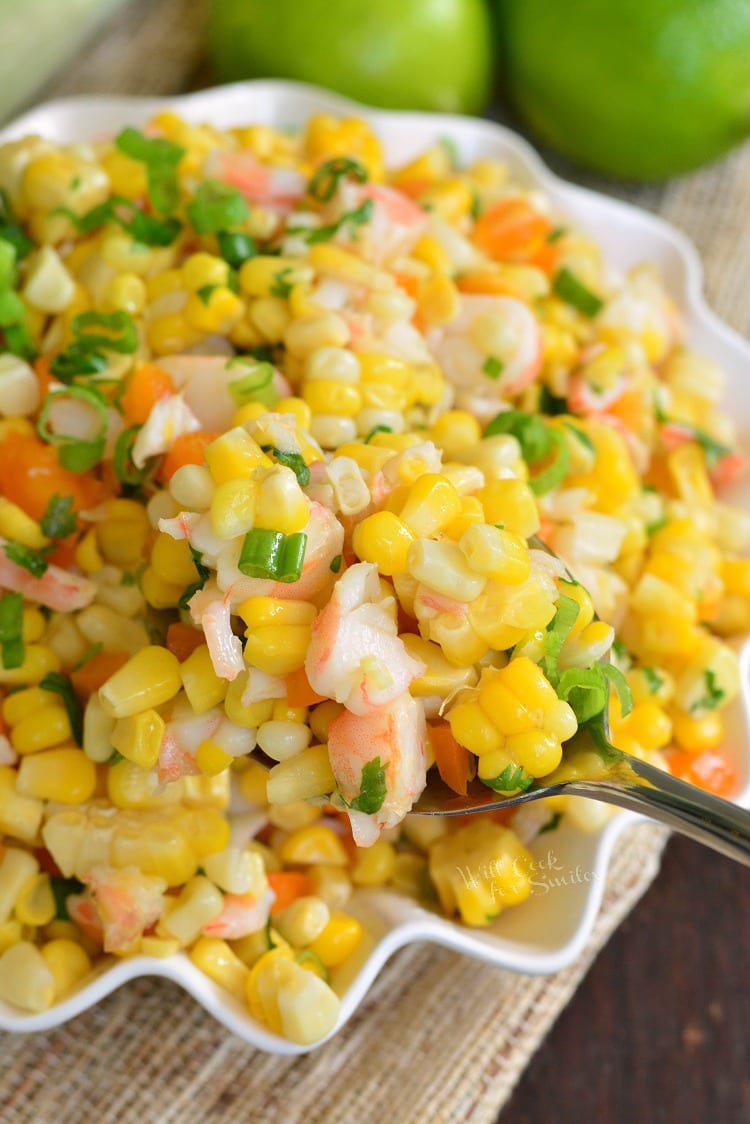 Cilantro Lime Shrimp Corn Salad in a bowl with a serving spoon 
