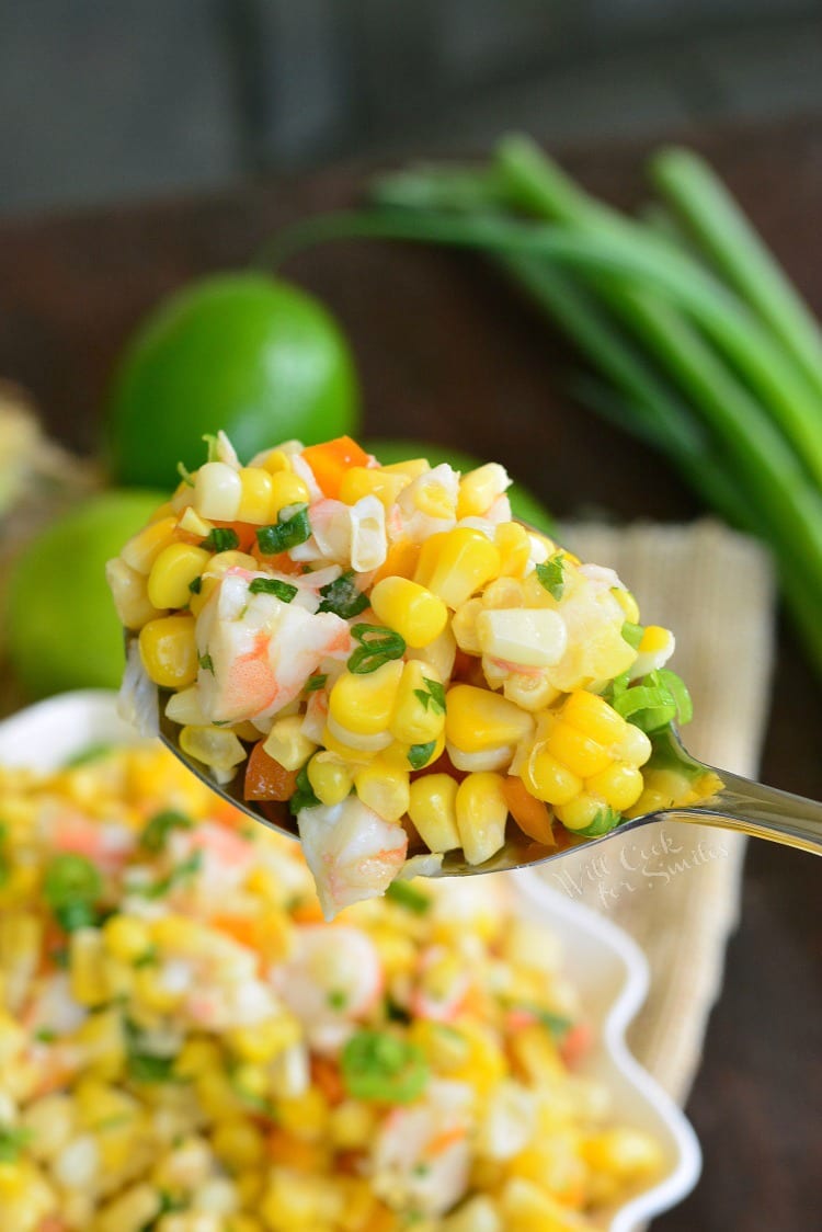 Cilantro Lime Shrimp Corn Salad in a bowl with a serving spoon scooping some out 