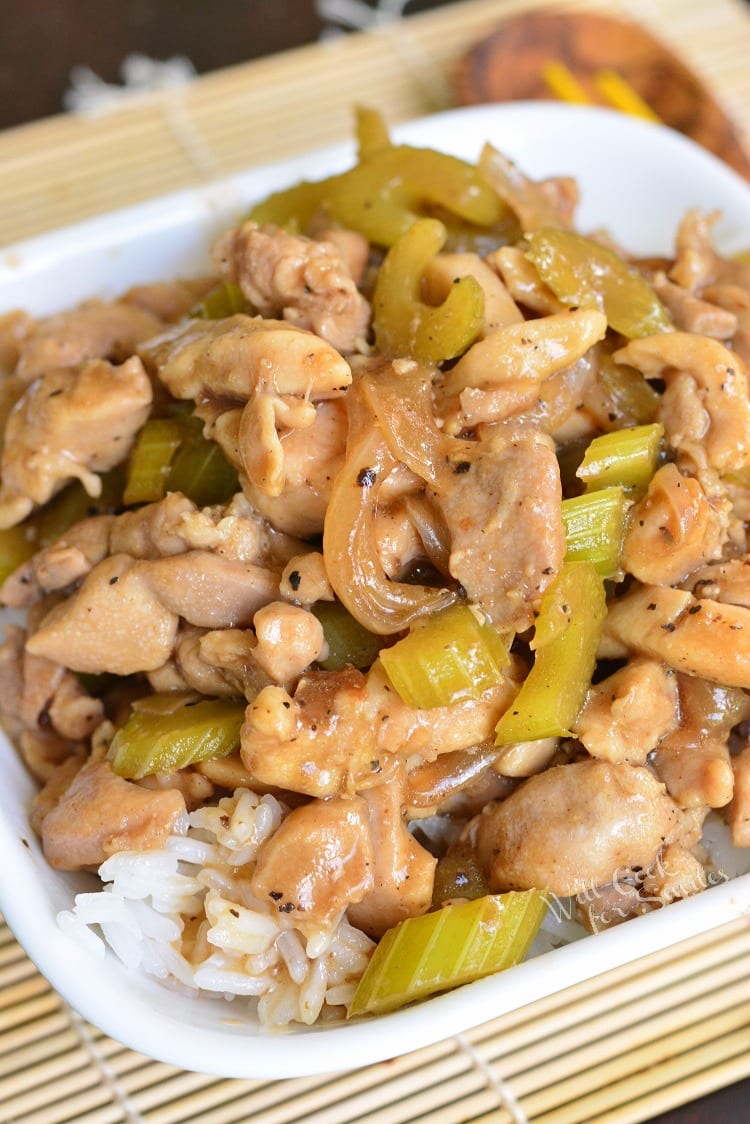 rice topped with cooked chicken, celery, and onions