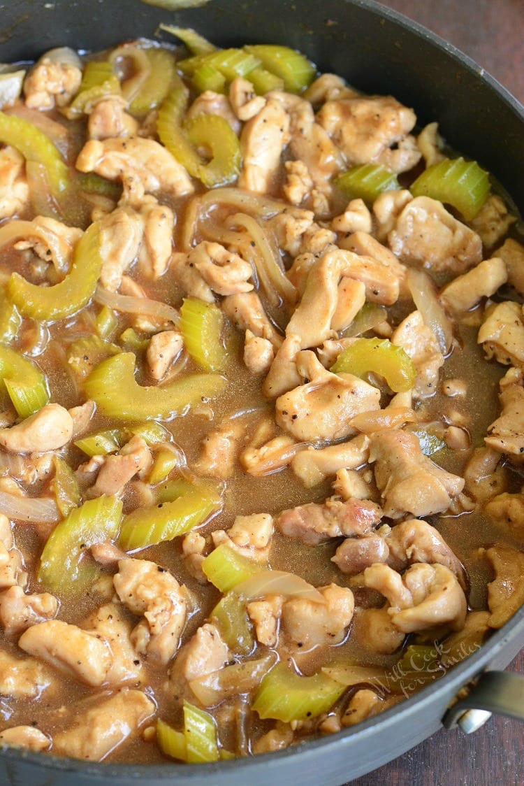 cooked chicken with celery and onions in a sauce in a pan