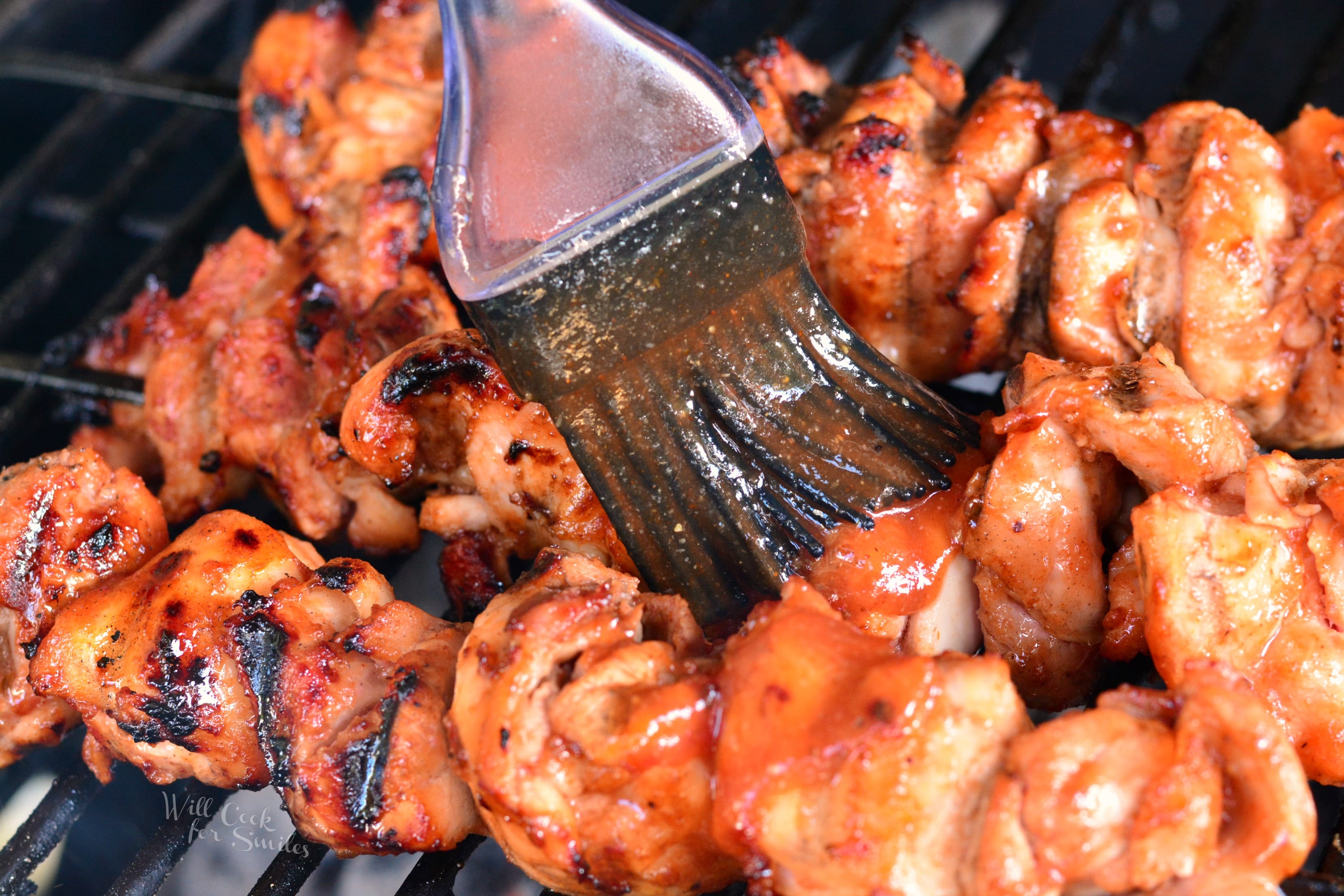 brushing Spicy BBQ sauce on Chicken Skewers 