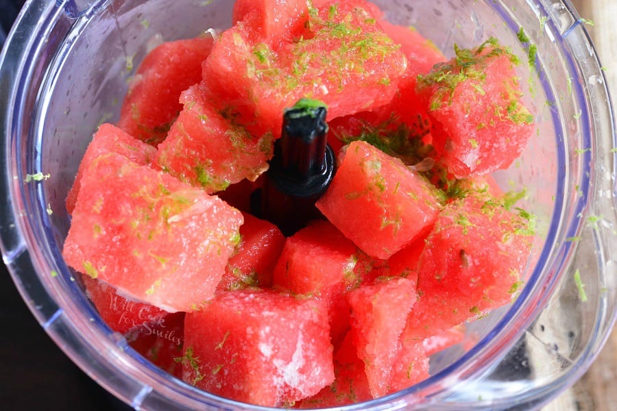 Watermelon cut into cubes and lemon zest in a food processor 