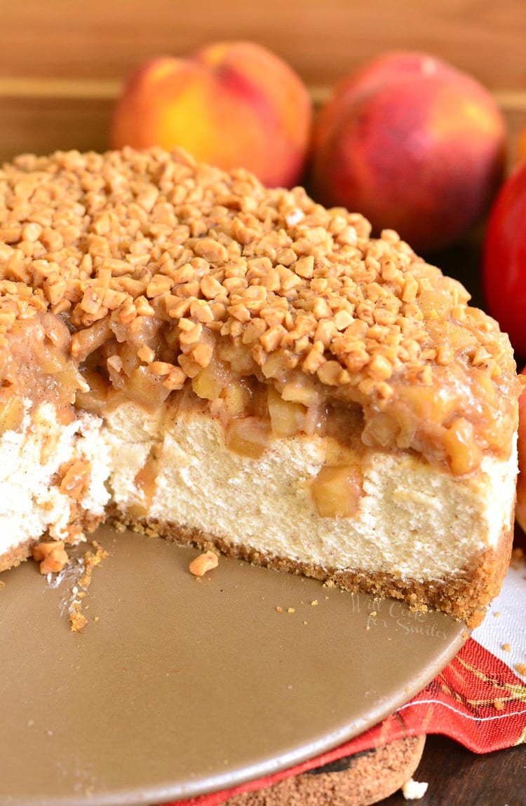 Apple Pie Cheesecake with apples on a cutting board 