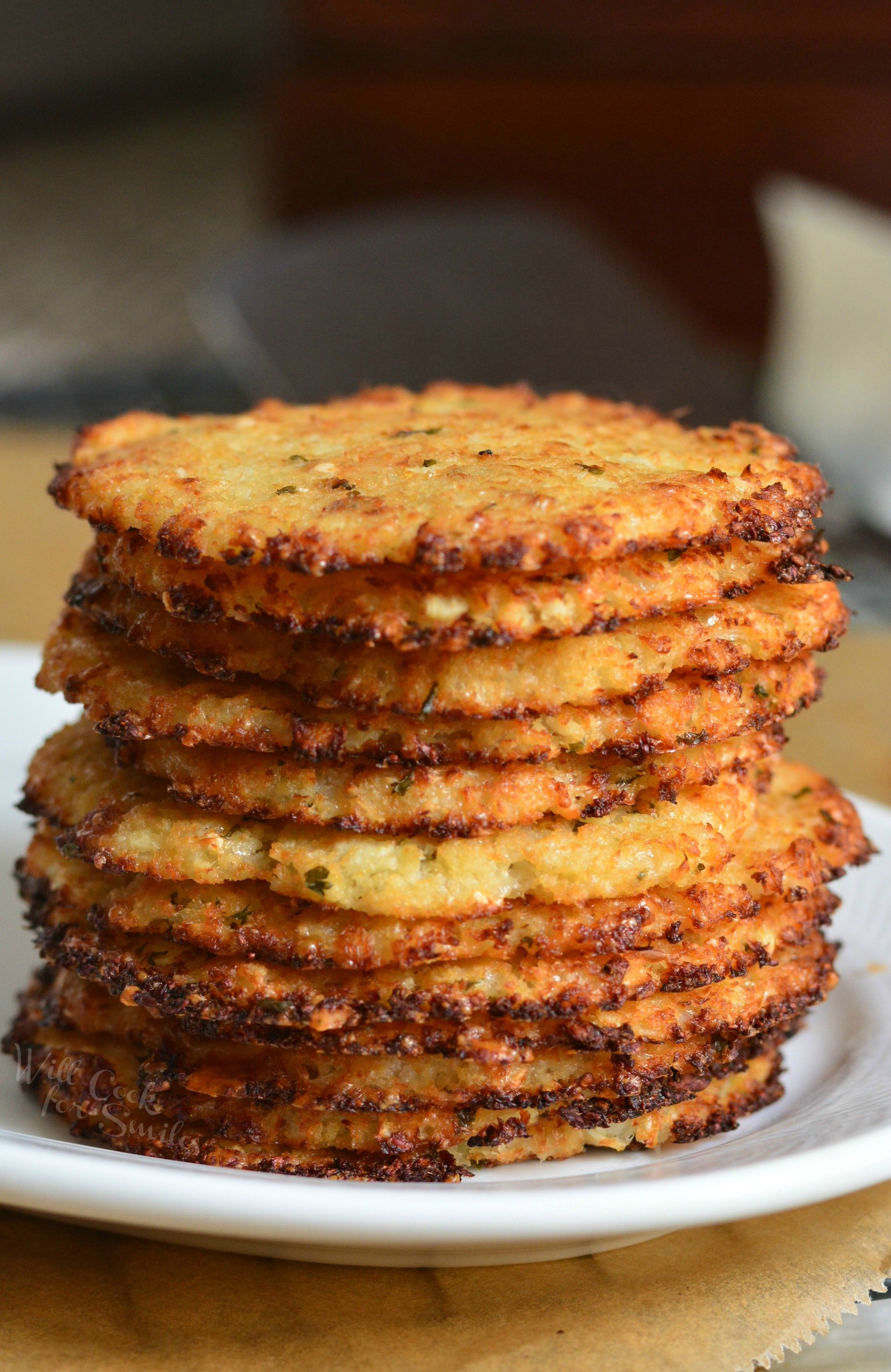 Cauliflower Parmesan Crisps. Amazing cauliflower snack that kids and adult will love. All you need is a head of cauliflower, block of Parmesan cheese, dry parsley flakes, and some garlic powder. #snack #cauliflower #parmesan 