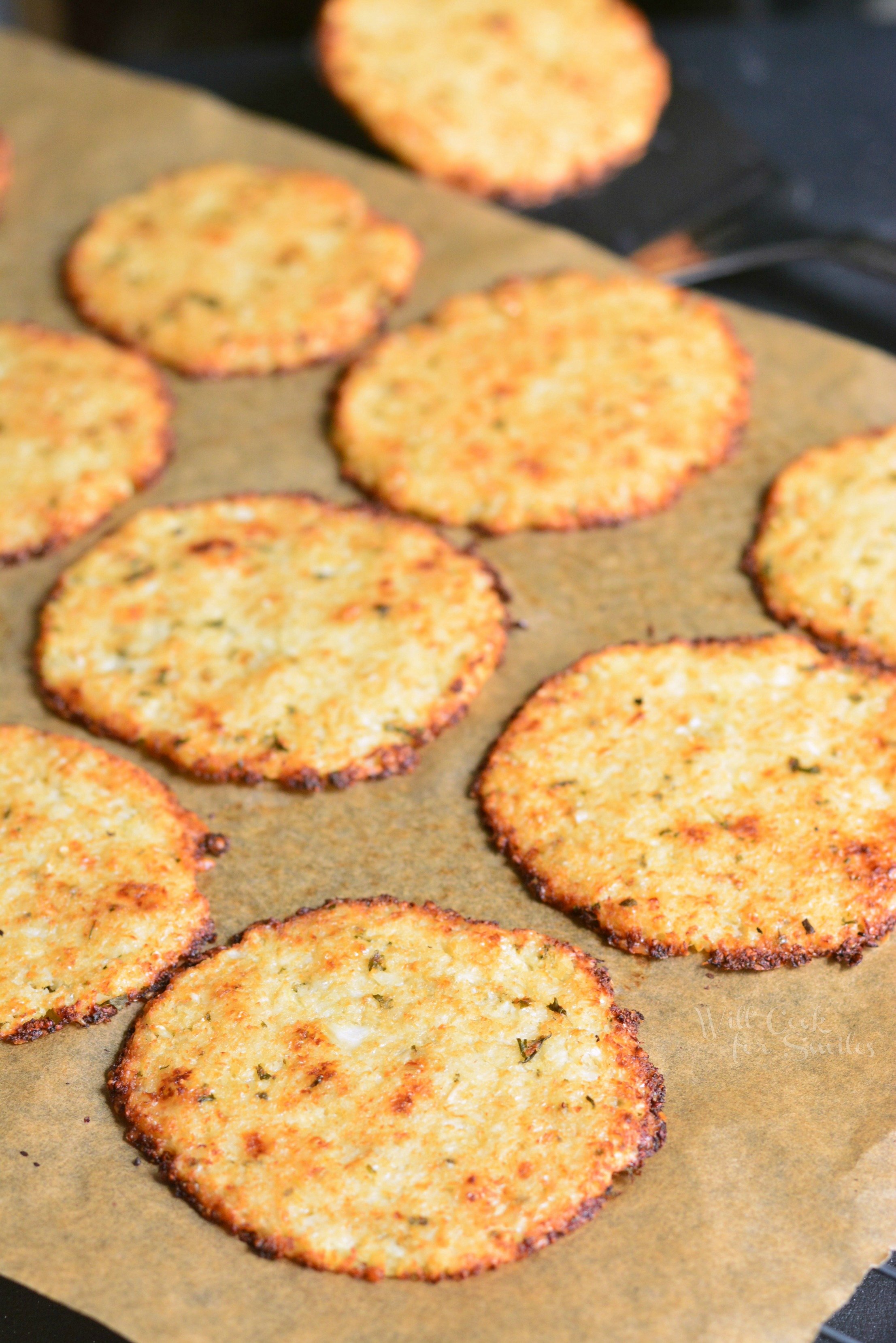 Cauliflower Parmesan Crisps. Amazing cauliflower snack that kids and adult will love. All you need is a head of cauliflower, block of Parmesan cheese, dry parsley flakes, and some garlic powder. #snack #cauliflower #parmesan 