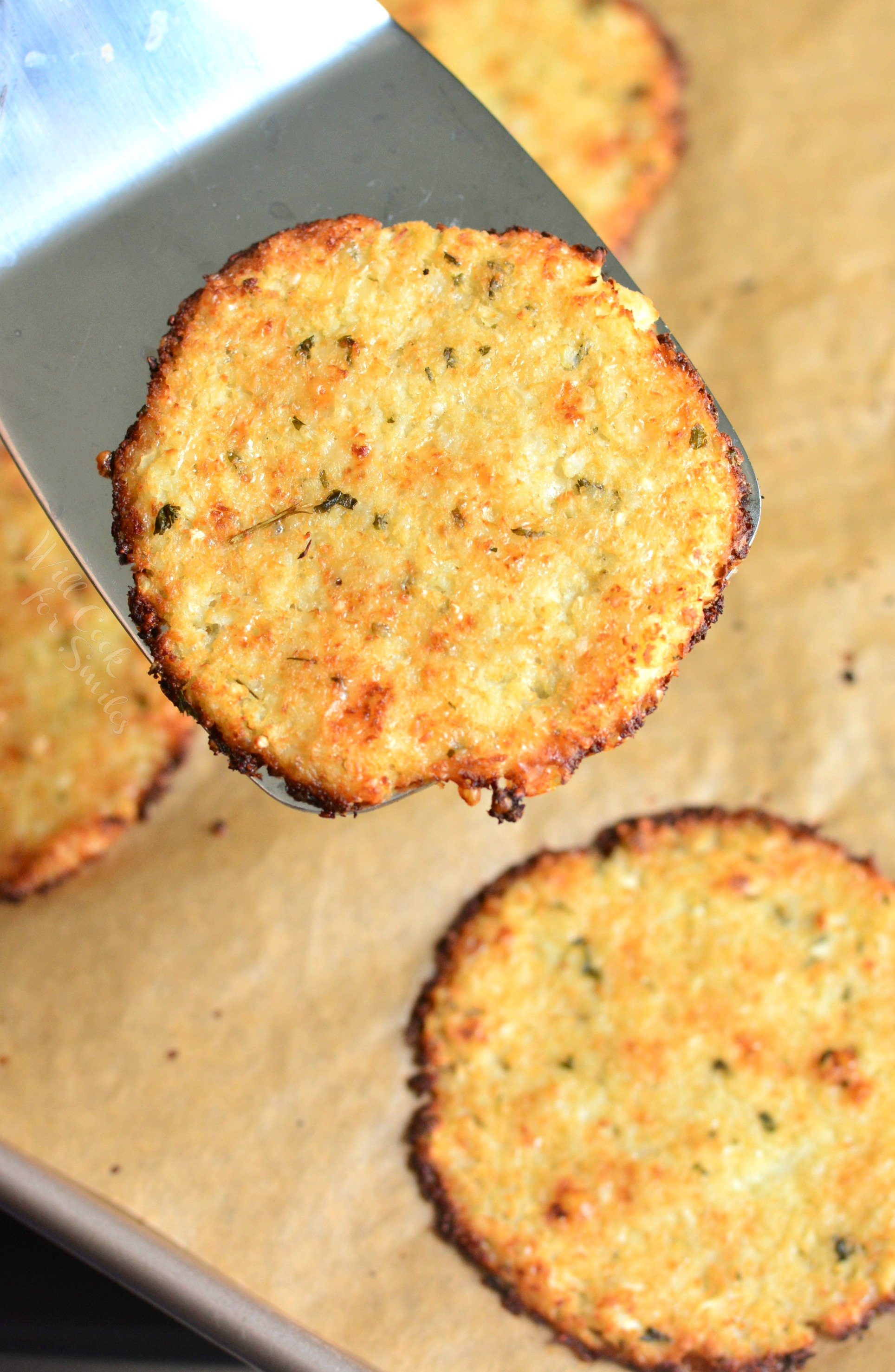 Cauliflower Parmesan Crisps. Amazing cauliflower snack that kids and adult will love. All you need is a head of cauliflower, block of Parmesan cheese, dry parsley flakes, and some garlic powder. #snack #cauliflower #parmesan 