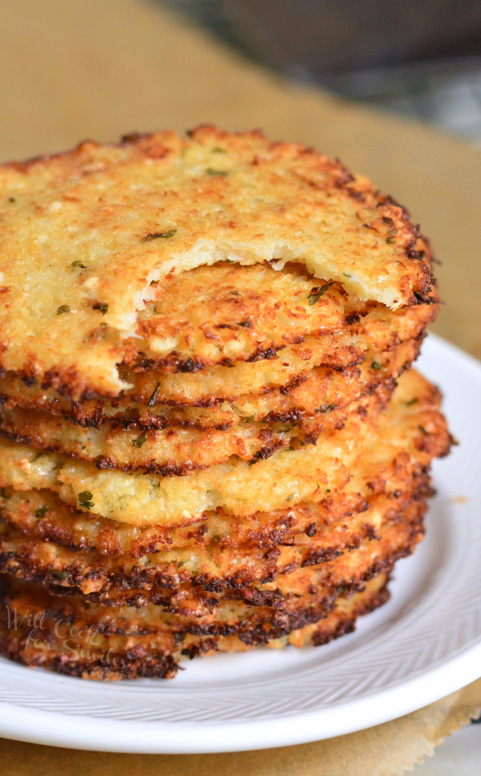 Cauliflower Parmesan Crisps. Amazing cauliflower snack that kids and adult will love. All you need is a head of cauliflower, block of Parmesan cheese, dry parsley flakes, and some garlic powder. #snack #cauliflower #parmesan 