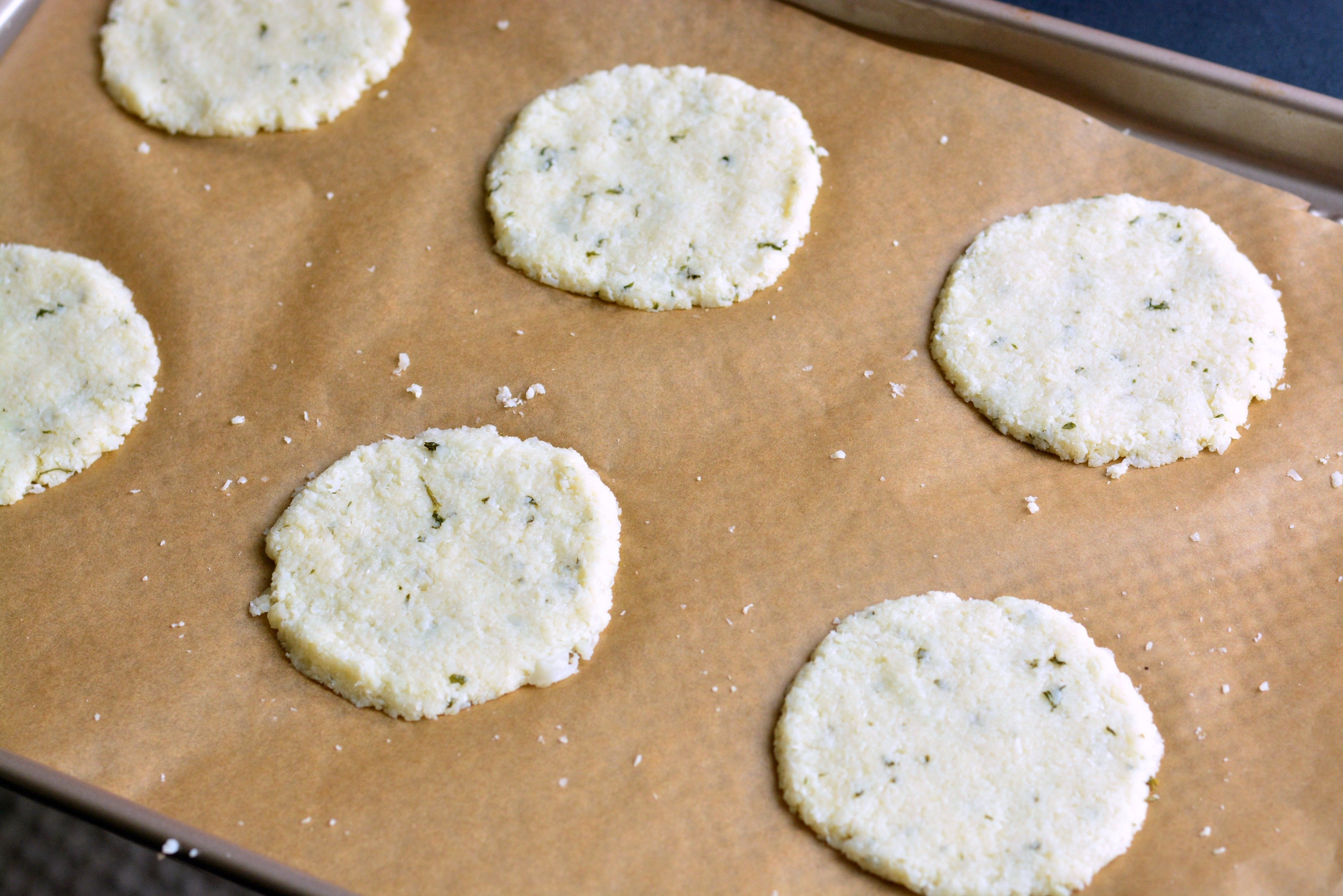 Cauliflower Parmesan Crisps. Amazing cauliflower snack that kids and adult will love. All you need is a head of cauliflower, block of Parmesan cheese, dry parsley flakes, and some garlic powder. #snack #cauliflower #parmesan 