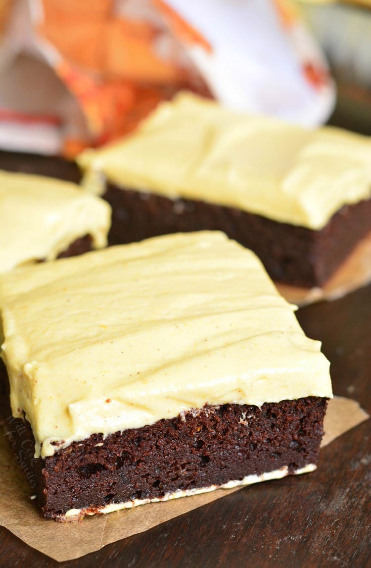 Frosted Pumpkin Brownie on parchment paper on a table top