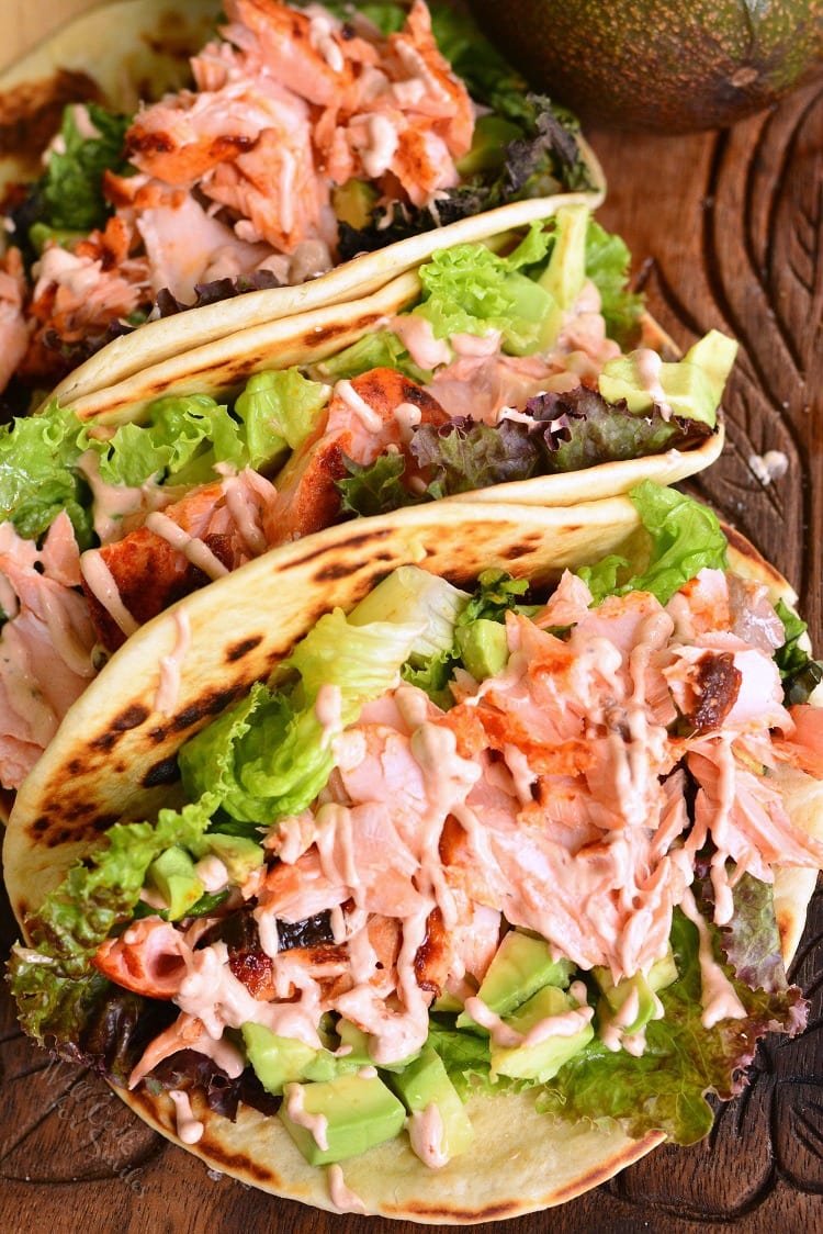 3 Easy Baked Salmon Tacos on a wood cutting board 