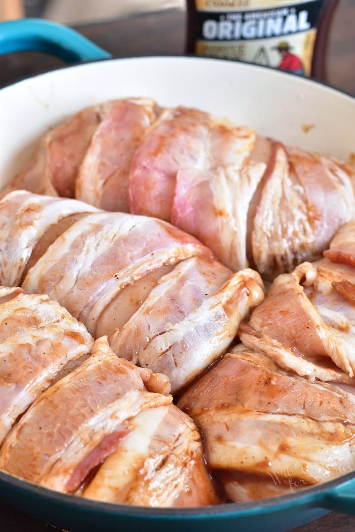Raw Chicken Wrapped in bacon in a pan 