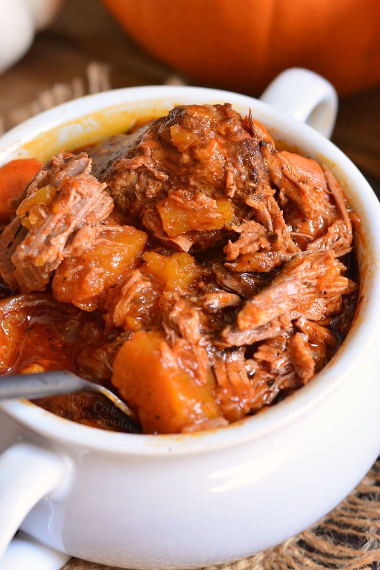 Crock Pot Roast with pumpkin in a bowl with a fork 