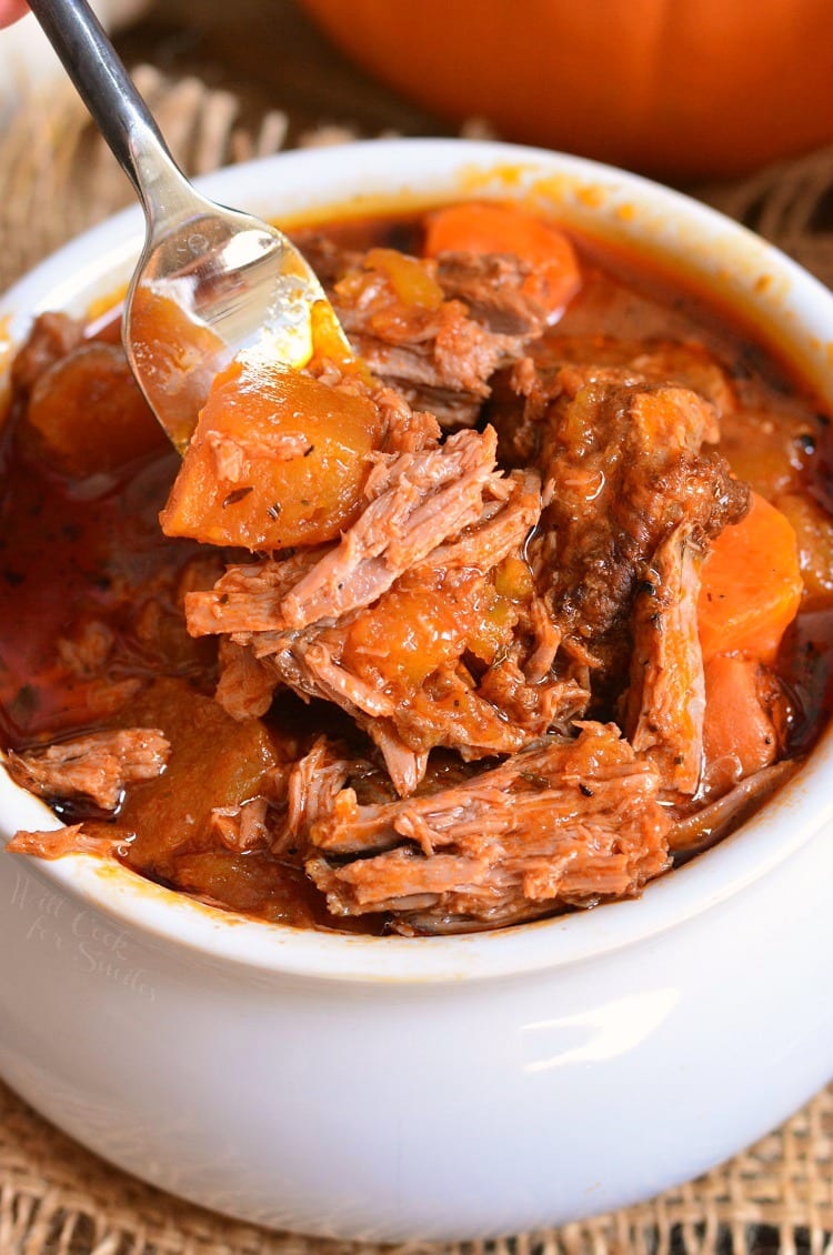 Crock Pot Roast with pumpkin in a bowl with a fork 