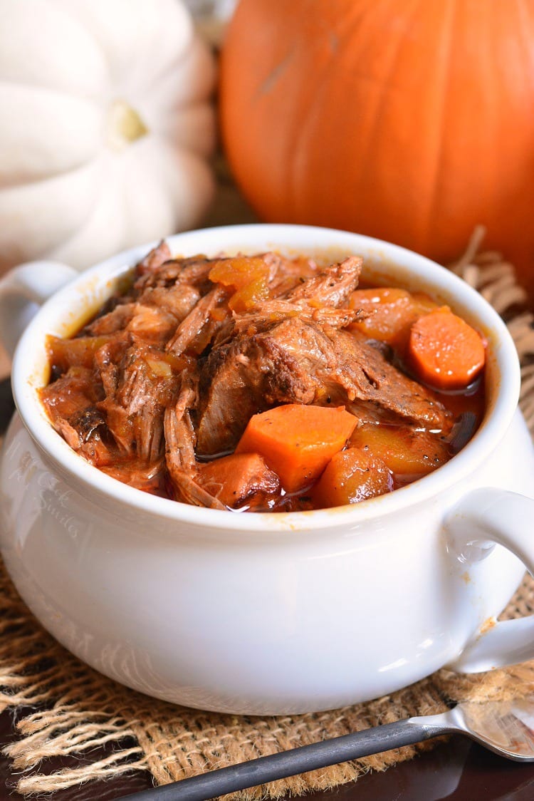 Crock Pot Roast Recipe in a bowl with pumpkins in the background 