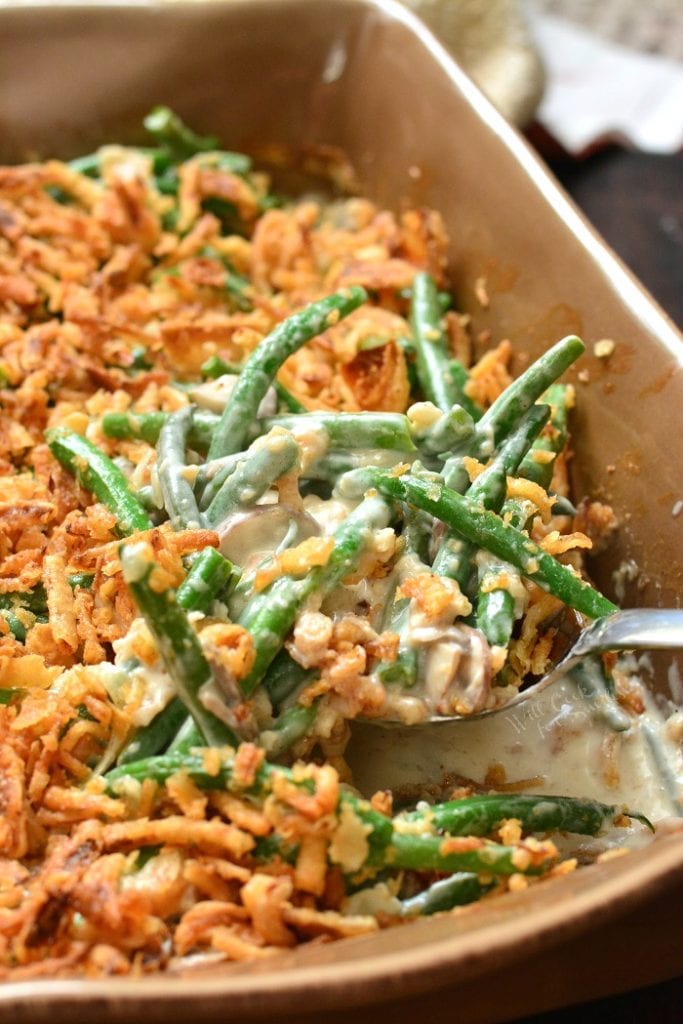 scooping out a portion of creamy green bean casserole.