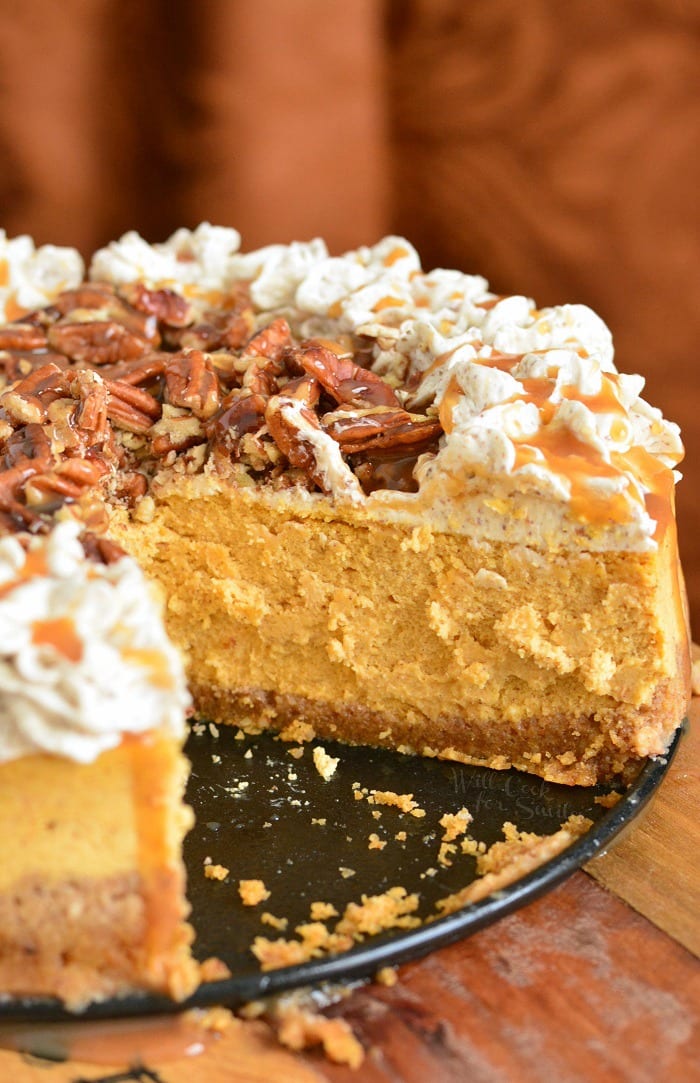 Pumpkin Cheesecake with Pecans and Caramel on a table 