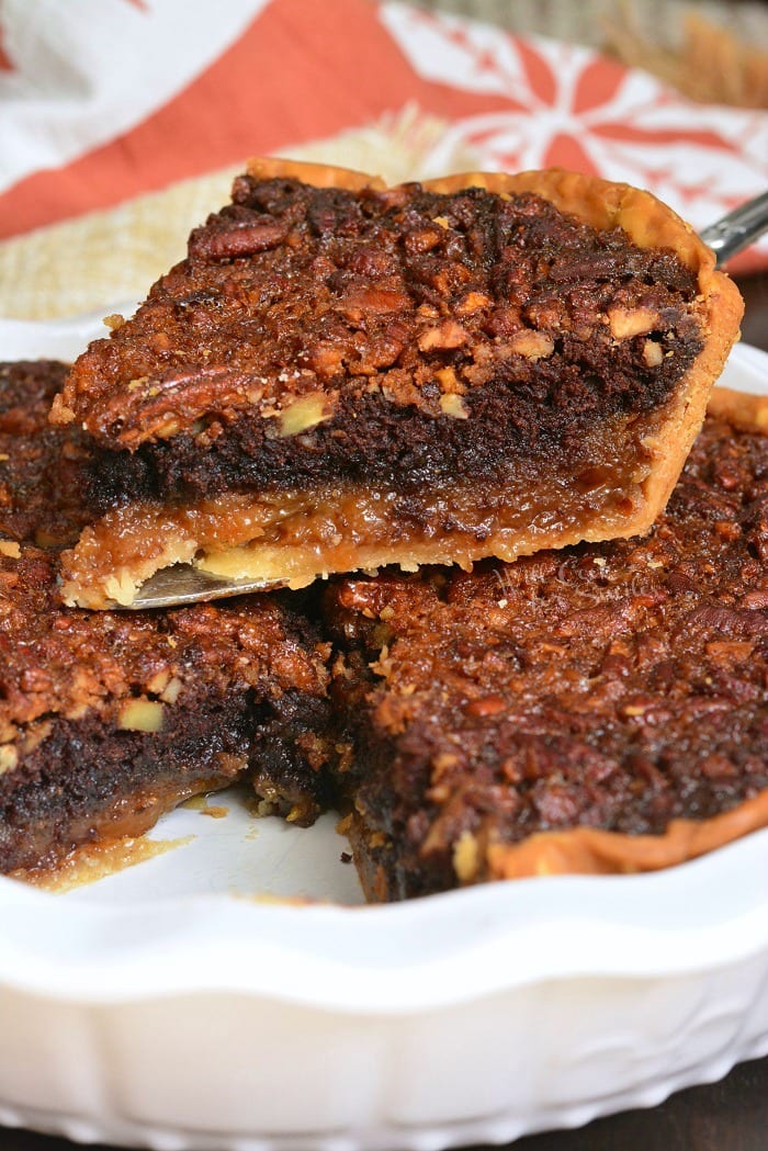 Brownie Pecan Pie being lifted out of pie pan 