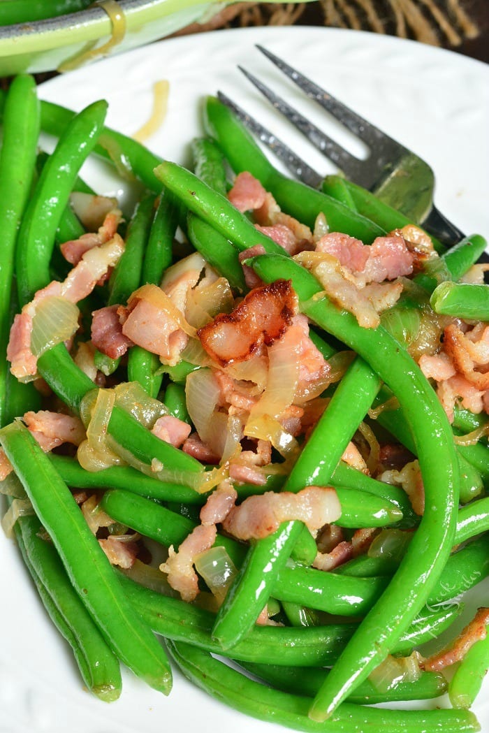 Green Beans Recipe with Bacon and Onion on a plate with a fork 