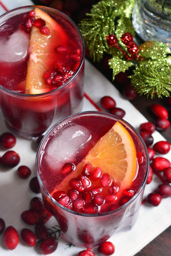 two Christmas Punch in a glass with pomegranate and orange slice 