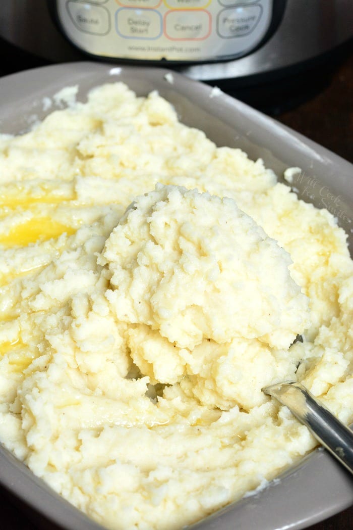 Instant Pot Garlic Mashed Potatoes in a pan with a metal spoon 