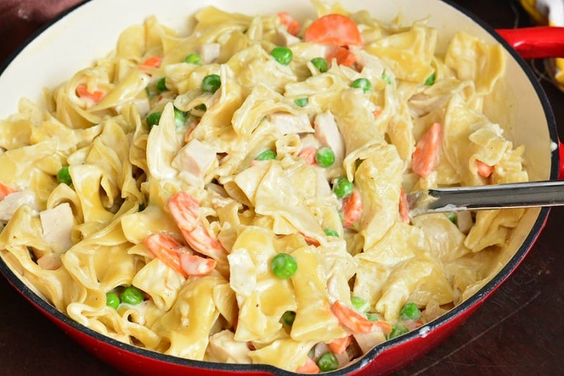 top view of creamy turkey noodles with veggies in a pan.