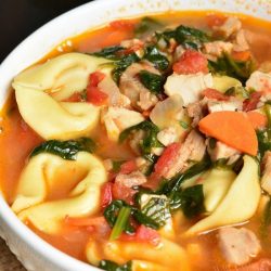 top closeup of a bowl of turkey tortellini soup.