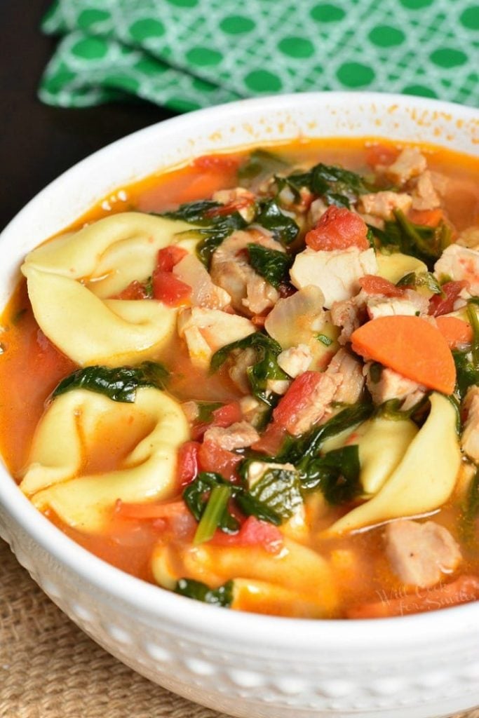 top closeup of a bowl of turkey tortellini soup.