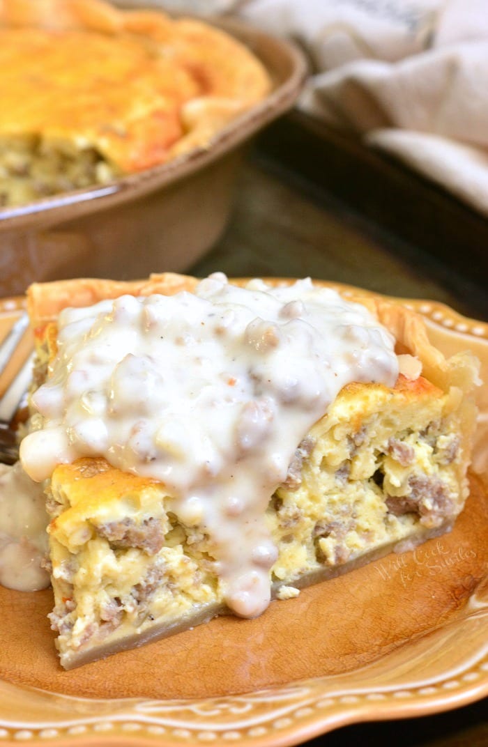 Close up of gravy covered quiche on a plate.