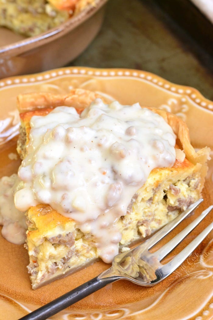 Quiche with Sausage Gravy on a yellow plate with a fork 