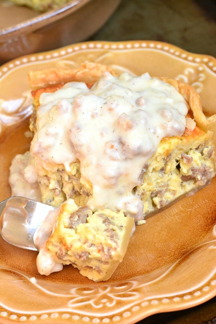 Quiche with Sausage Gravy on a yellow plate with a fork 