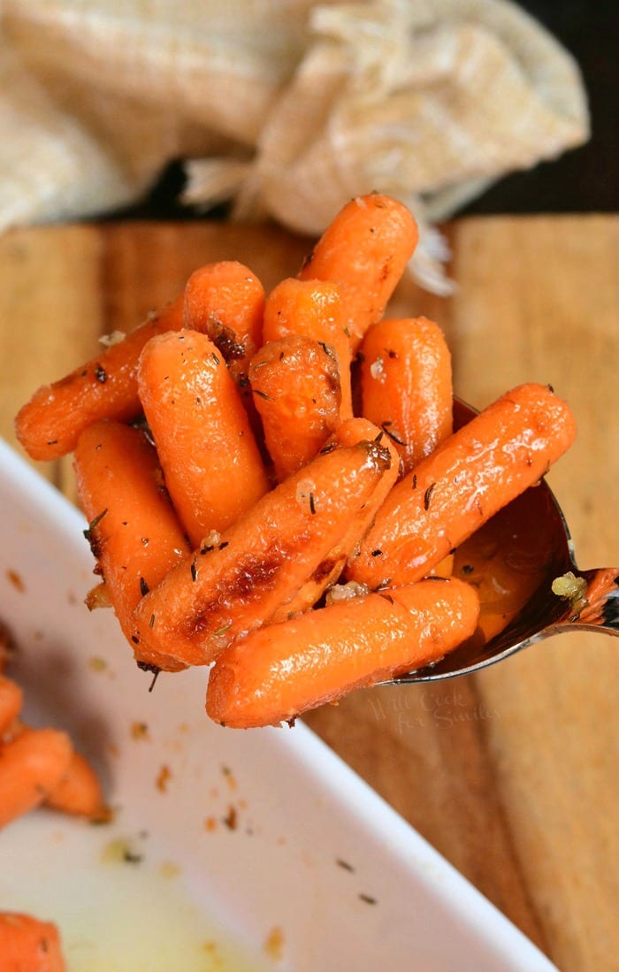 Balsamic Roasted Carrots being dipped out with a serving spoon 