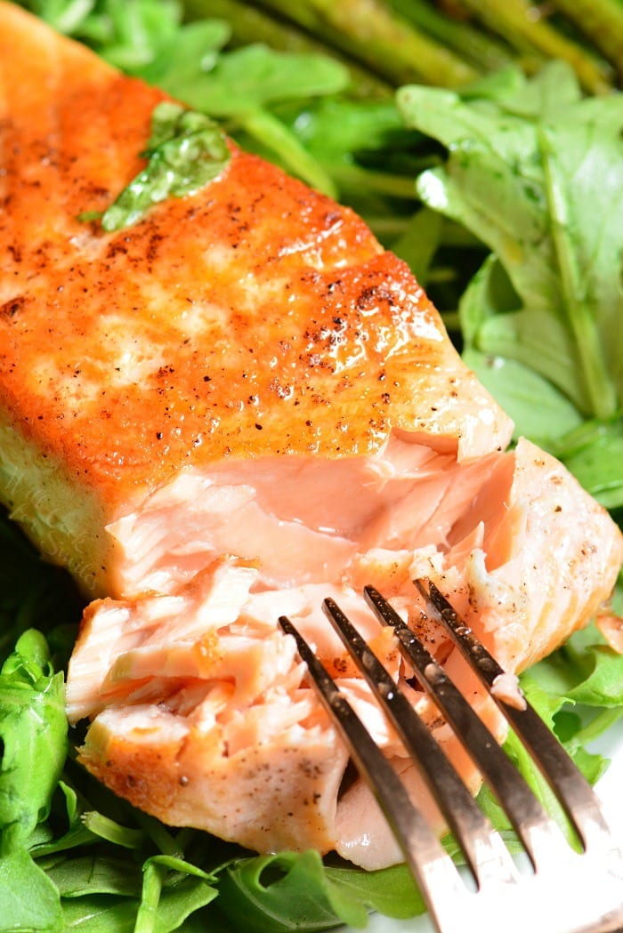 Crispy Skin Salmon on a bed of lettuce with a fork 