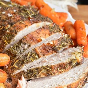 sliced pork loin on the white plate with carrots.