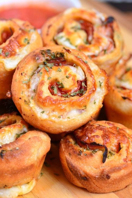 closeup of Italian sub pinwheels stacked on the cutting board