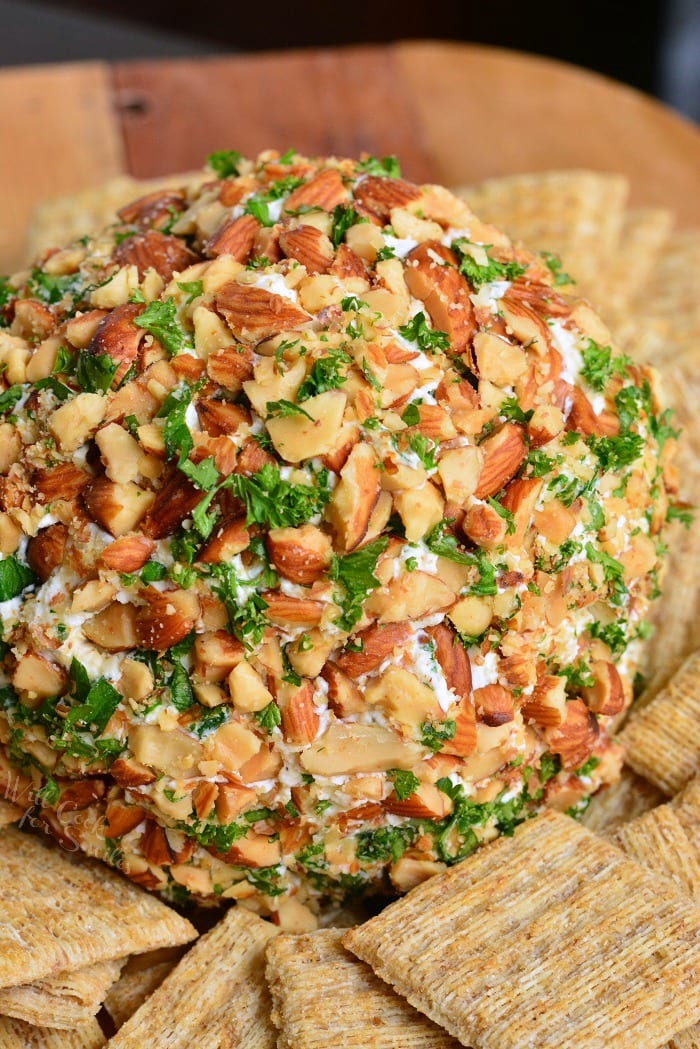 Ranch Cheddar Cheese Ball with wheat crackers on a cutting board 