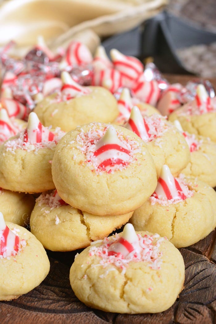 Thumbprint Cookies with Candy Cane Kisses on a wood cutting table 