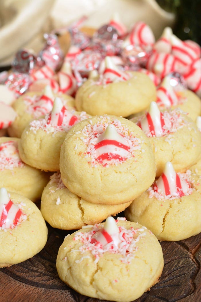 Thumbprint Cookies with Candy Cane Kisses on a wood cutting table 