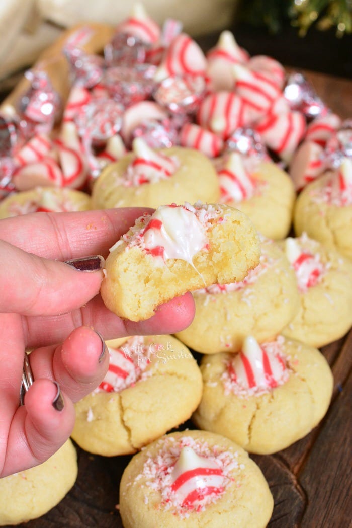 Thumbprint Cookies with Candy Cane Kisses on a wood cutting table 