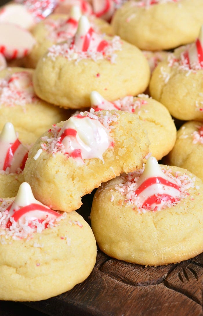 Thumbprint Cookies with Candy Cane Kisses on a wood cutting table 