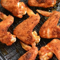 baked chicken wings in the rack inside a baking sheet.